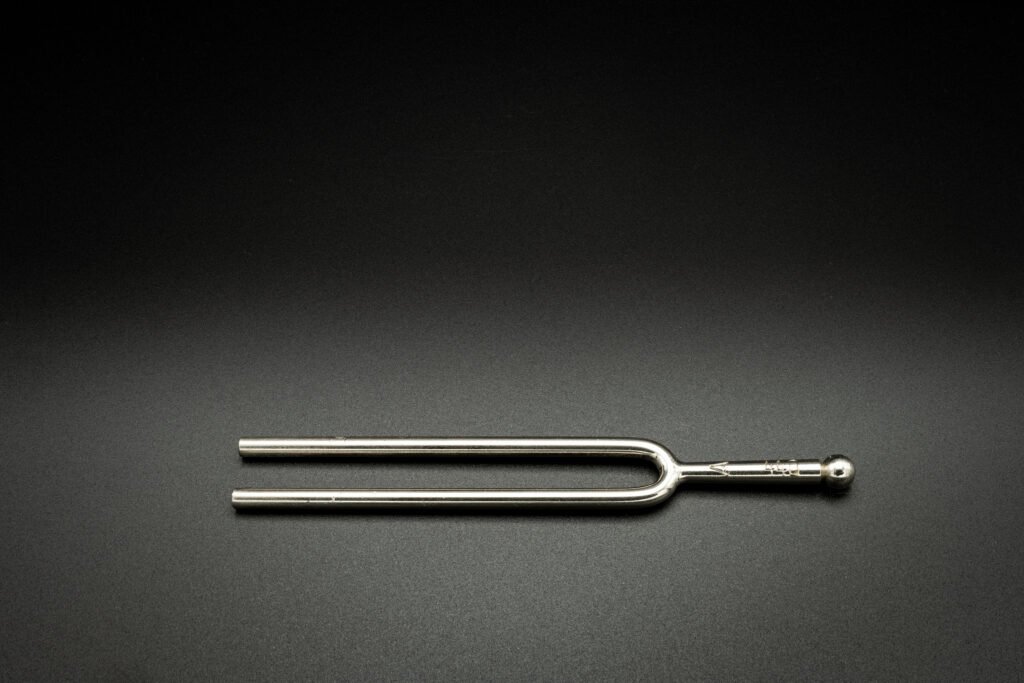 a tuning fork 440 hz on a black background