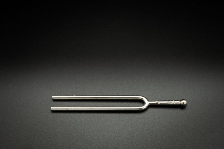 a tuning fork 440 hz on a black background
